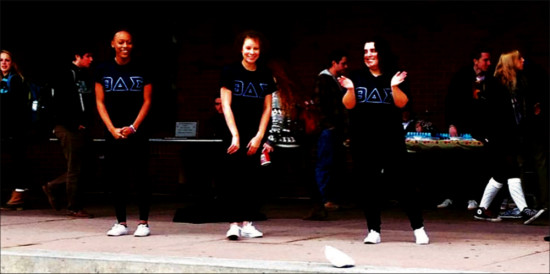 (Left to right) Fraternity members sophomore Sha’Kylah Morris, junior Sheila Cruz and graduate Lynn Wales perform an initiation ritual in front of the Bailey/Howe Library Nov. 19. photo courtesy of Theta Sigma Delta at UVM