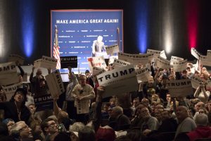 A crowd of attendees look on people protesting Trump inside the Flynn Dec. 7. RYAN THORNTON/The Vermont Cynic